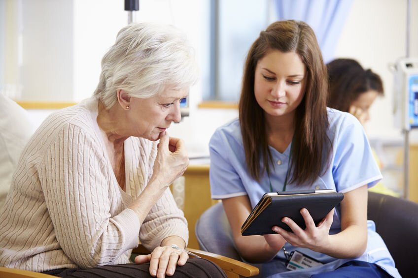 a nurse and a patient looking at a tablet