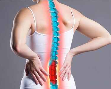 a woman with back pain holding her hands on her hip