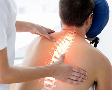 Chiropractor treating a patient's back with a graphic overlay of spine structure.