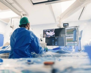 a person in a hospital room with a monitor